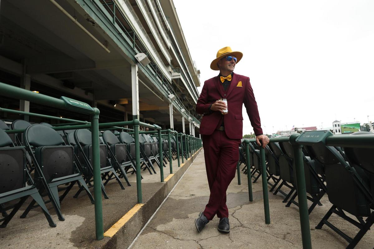 Aaron Megel, from Indianapolis, poses for a picture In an outfit inspired by Jim Carrey’s movie “The Mask” at Churchill Downs in Louisville, Ky., Saturday, May 7, 2022.