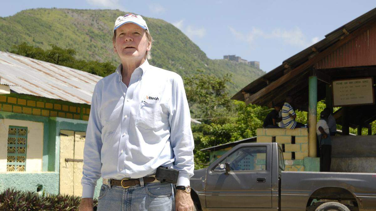 Alltech president Pearse Lyons toured Dondon, Haiti, location of a coffee bean-processing cooperative. In the background is 
Citadelle Laferrière, a historic Haitian fortress. Lyons said he may name Alltech's new coffee products after the fortress.