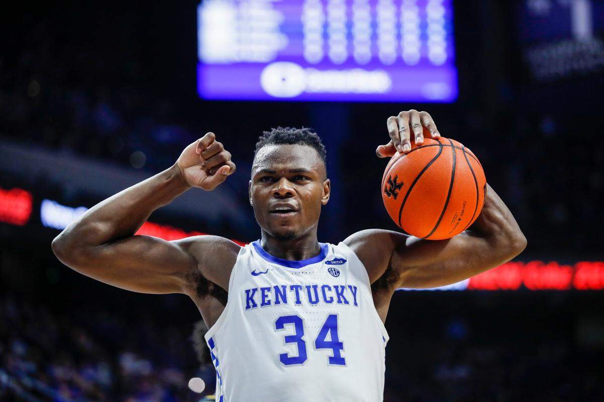 Kentucky Wildcats forward Oscar Tshiebwe (34) flexes his muscles while holding the ball going into a time out during the game against the Missouri Tigers at Rupp Arena in Lexington, Ky., Wednesday, December 29, 2021.