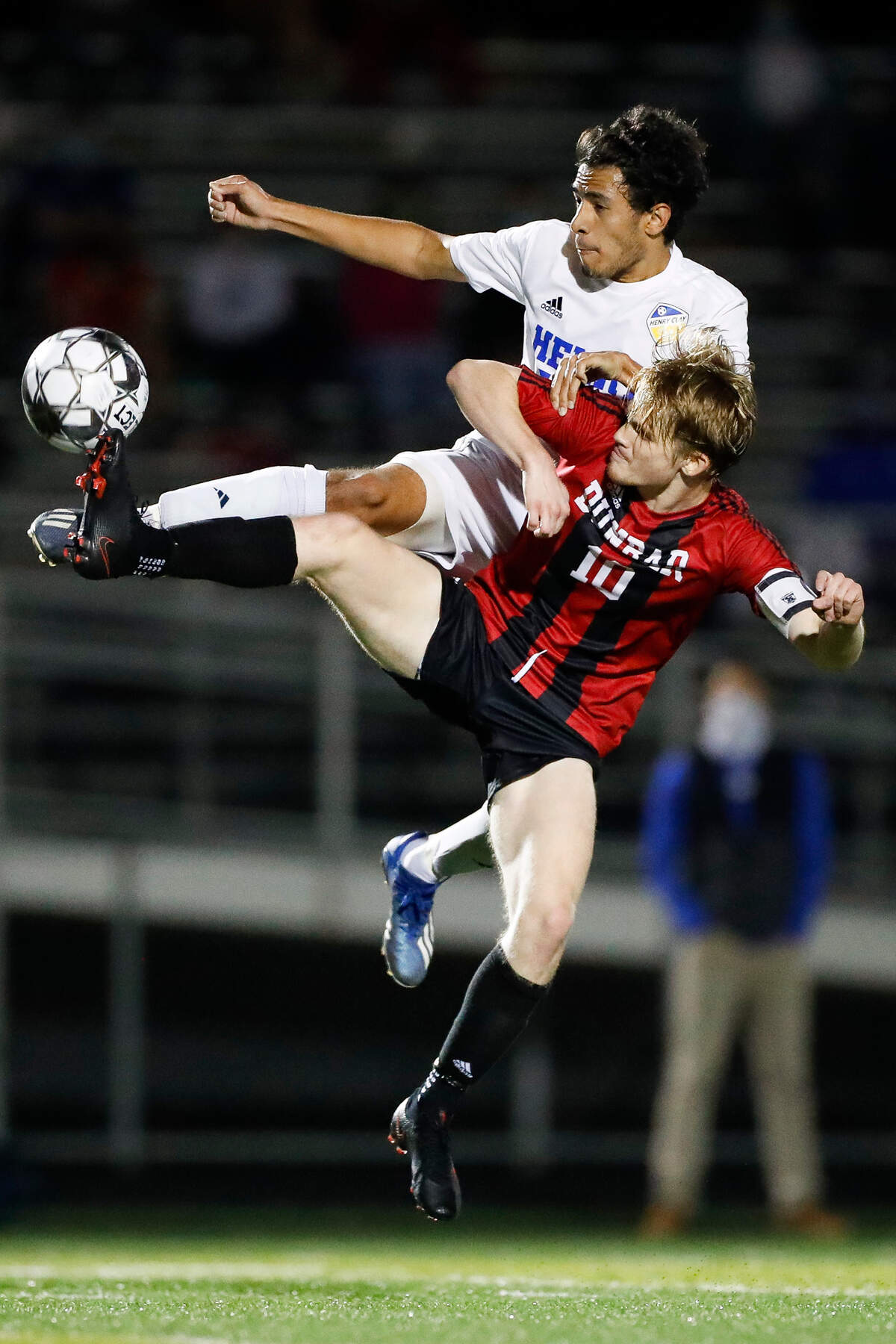 Paul Laurence Dunbar’s Drew Doza (10) and Henry Clay’s Nishan Budhathoki (20) jump for the ball during the 11th Region soccer championship at Frederick Douglass High School in Lexington, Ky., Thursday, Oct. 22, 2020. Paul Laurence Dunbar beat Henry Clay 1-0 on penalty kicks.