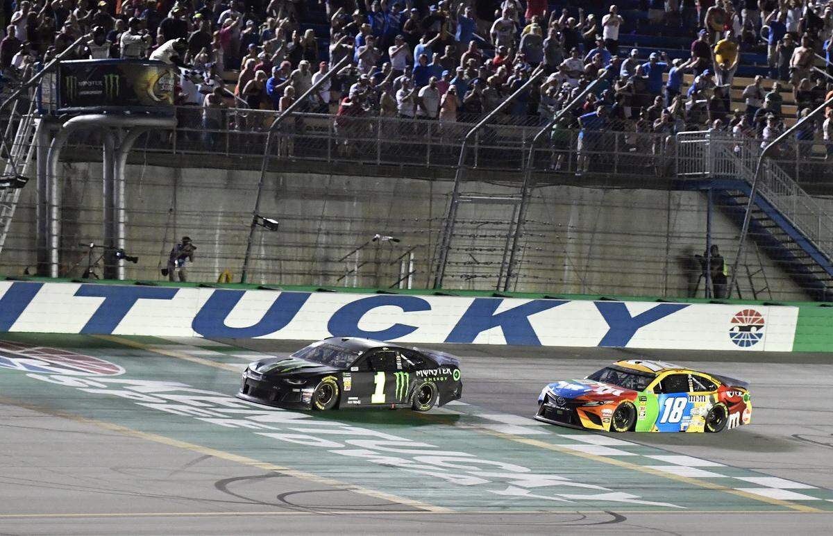 Kurt Busch (1) crossed the finish line just ahead of younger brother Kyle Busch (18) to win the 2019 Quaker State 400 at Kentucky Speedway.