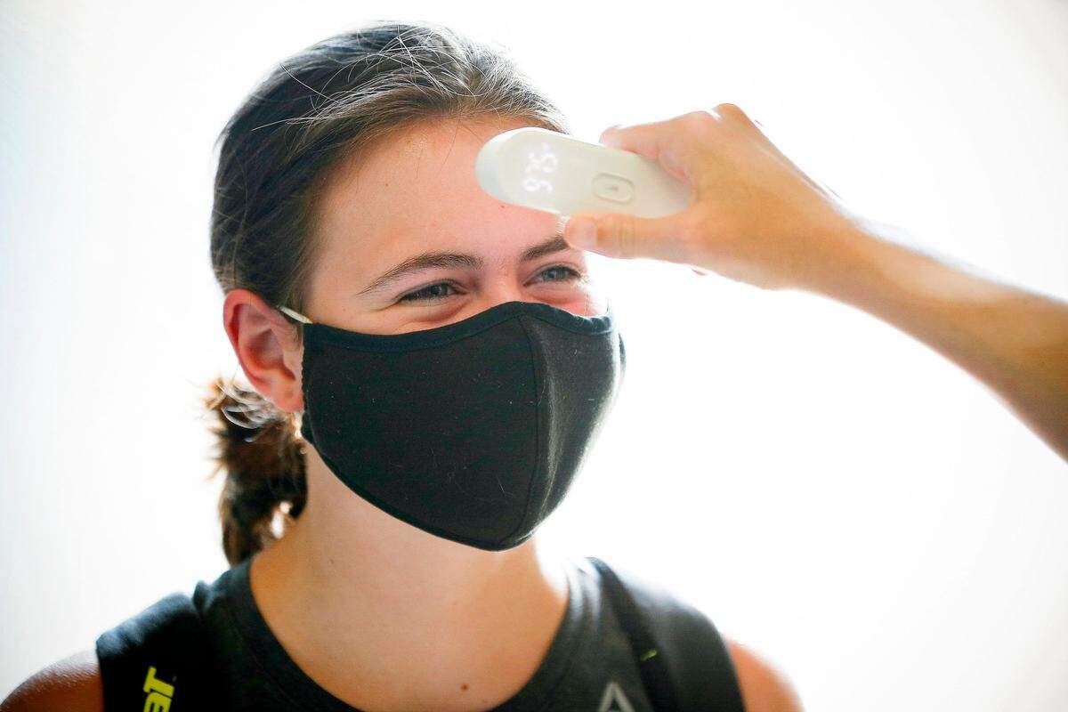 A Lafayette High School soccer player had her temperature checked before beginning a voluntary workout on Wednesday evening, July 29, 2020.