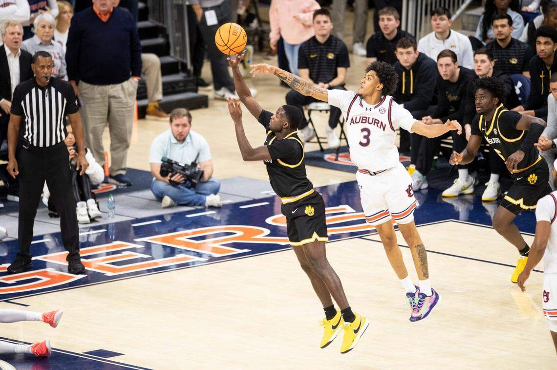 Missouri Tigers guard Marques Warrick (1) draws a foul on Auburn Tigers forward Jahki Howard (3) as Auburn Tigers take on Missouri Tigers at Neville Arena in Auburn, Ala., on Saturday, Jan. 4, 2025. Auburn Tigers defeated Missouri Tigers 84-68.