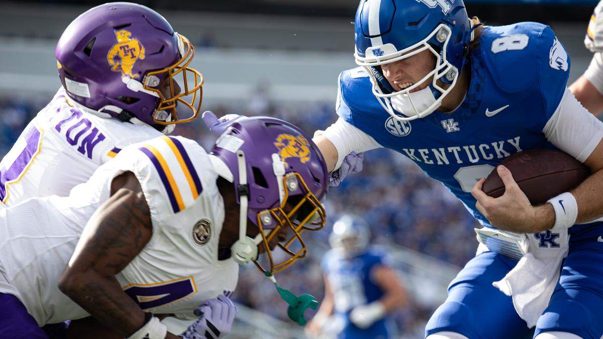 Kentucky quarterback Cutter Boley, right, fights his way into the end zone during the Wildcats’ win against Tennessee Tech on Saturday at Kroger Field.