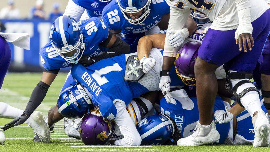 Tennessee Tech running back Quintell Quinn, bottom of pile, is brought down by a host of UK defenders including defensive lineman Mi'Quise Humphrey-Grace (90), linebacker Daveren Rayner (7), defensive back Grant Grayton (30) and linebacker Grant Godfrey (22).