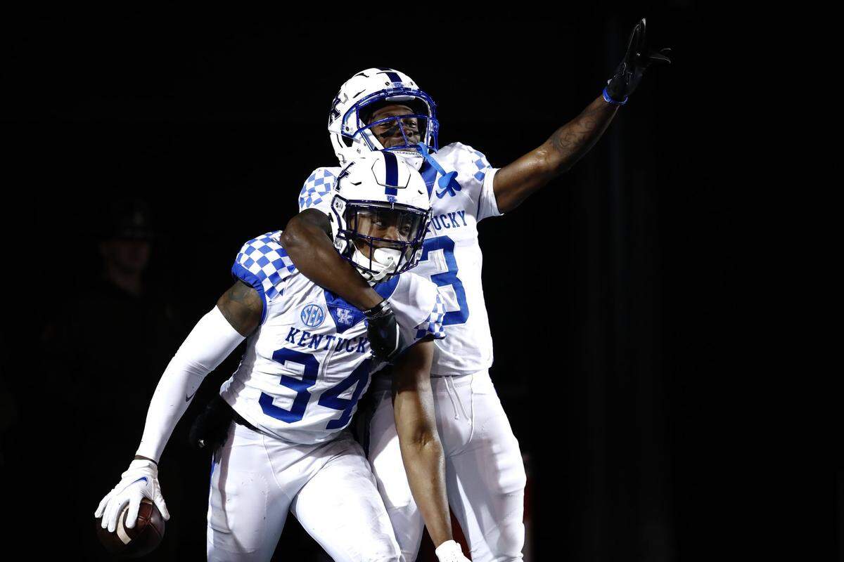 Jalen Geiger (left) celebrated with another UK defender after returning an interception for a touchdown on Saturday.