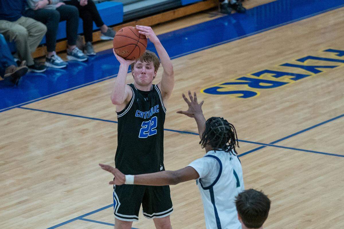 Lexington Catholic’s John Reinhart (22) takes a shot against Great Crossing at Franklin County High School on Saturday Jan. 28. The Knights won 61-52.