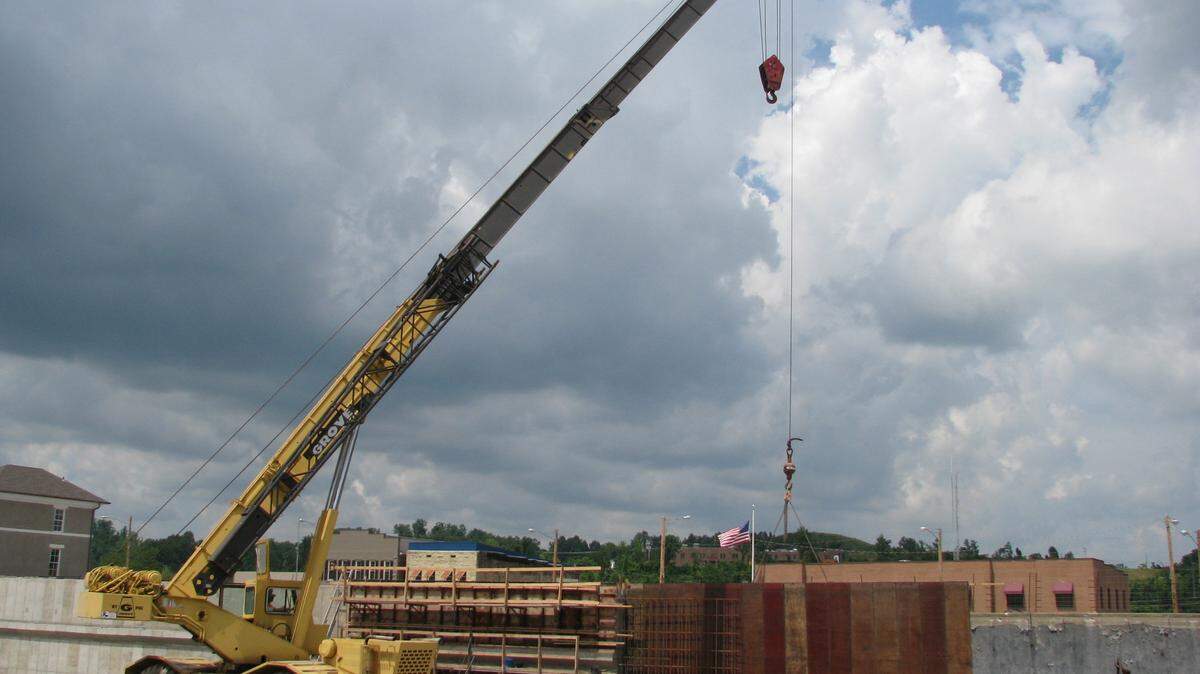 A crane with Frederick & May Construction set a form Thursday to erect a concrete wall for the Morgan County Transit Center in West Liberty. Photo taken on Thursday, June 19, 2014.