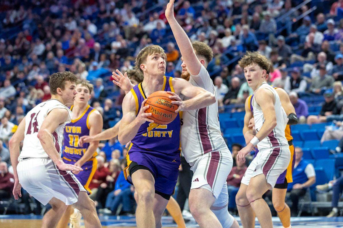 Lyon County’s Brady Shoulders (22) operates near the basket against Ashland Blazer’s Nate Freize (33) during their first-round state tournament game in Rupp Arena on Wednesday. Shoulders led the Lyons with 17 points, including the game-winning free throws in the closing seconds.
