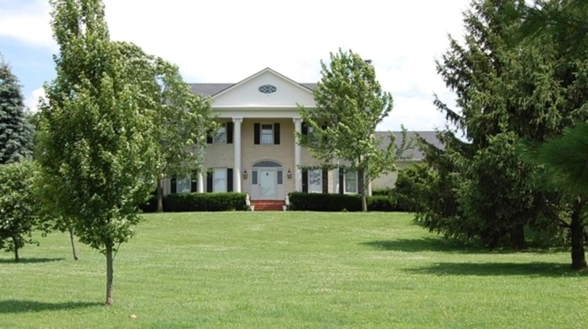 The five-bedroom colonial homestead sits on 82 acres. It includes the main house, two staff homes, and four horse barns. 