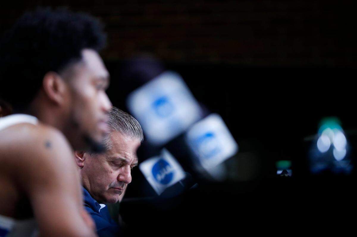 Kentucky Coach John Calipari listens to his players answer questions from reporters after losing to the Saint Peter’s in the NCAA Tournament.