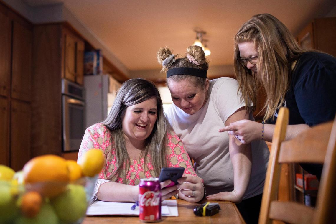 Megan shares a laugh with friends while taking a break from her NA step work in after group class at Living Clean transitional housing in Manchester, Ky., Wednesday, March 2, 2022.