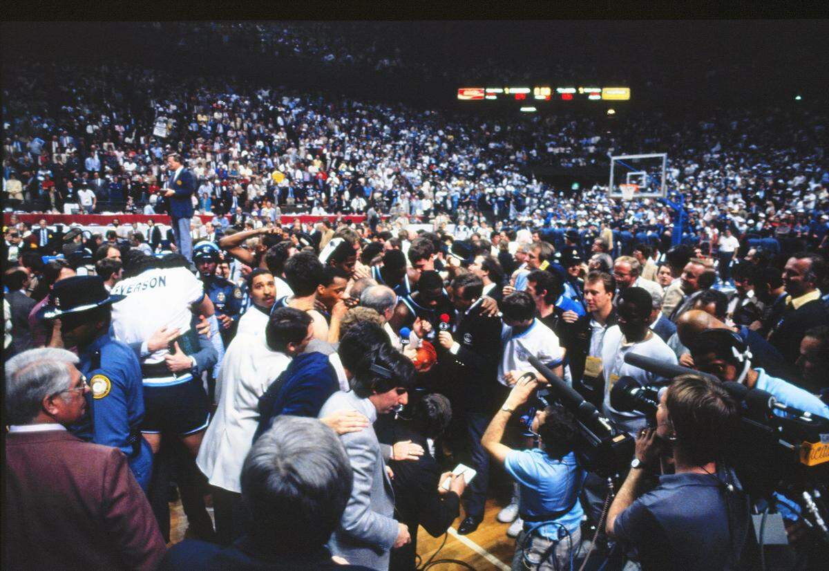 The Villanova team is swarmed by fans and media members after knocking off Georgetown in the NCAA Tournament championship game at Rupp Arena on April 1, 1985. Eighth-seeded Villanova, coached by Rollie Massimino, won the national title with a 66-64 victory over Georgetown, coached by John Thompson.