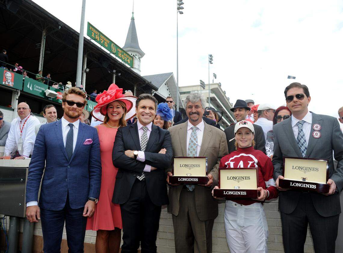 Actor and Longines ambassador of elegance Simon Baker, left, joined Jennifer Judkins, second left, and Juan-Carlos Capelli, third left, both of Longines, to award trainer Steve Asmussen, jockey Rosie Napravnik and owner Ron Winchell, left to right, with their Longines timepieces after their horse Untapable won the Longines Kentucky Oaks in 2014, in Louisville. Winchell is co-owner of Combatant, who is expected to be in the field for this week's Kentucky Derby.