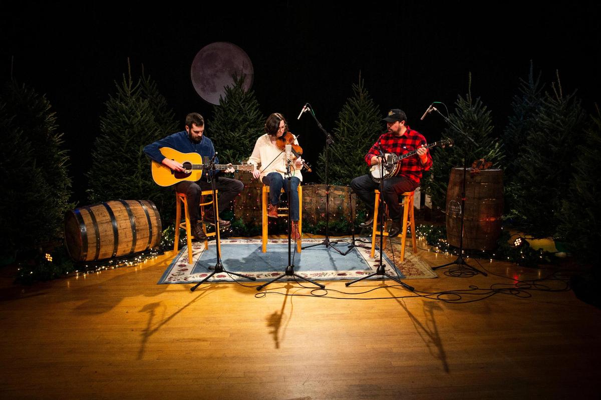 The Wells family, including Carrie Wells, center, her husband Matthew, left, and her brother, Jesse, right, perform during the taping of Red Barn Radio’s Christmas special, An Appalachian Christmas, in Lexington, Ky., on Wednesday, Dec. 2, 2020. The Wells are one of three families of musicians to be featured in An Appalachian Christmas.