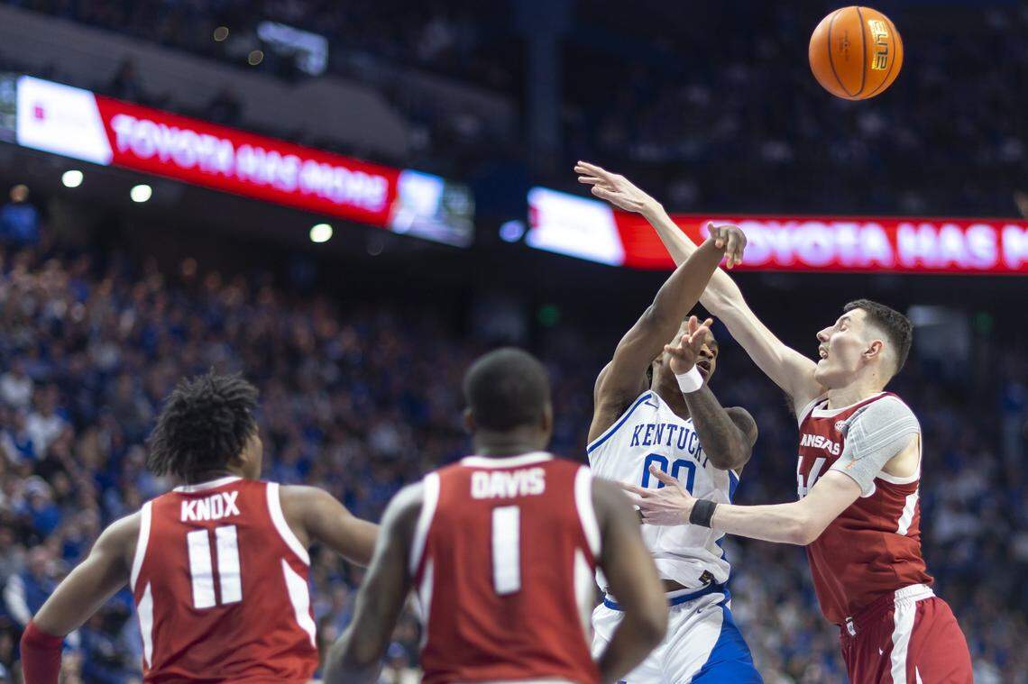 Kentucky guard Otega Oweh (00) tries to pass the ball past Arkansas forward Zvonimir Ivisic (44) during Saturday’s game at Rupp Arena.