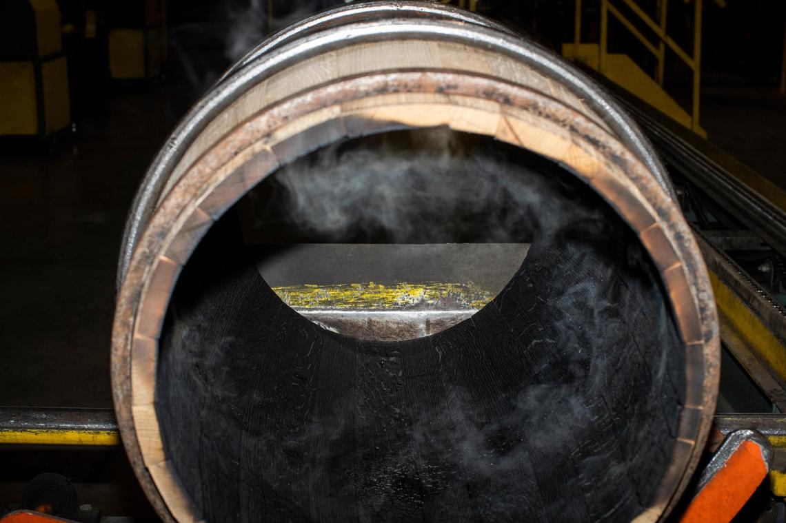 Bourbon barrels made from white oak logs are charred inside on Dec. 13, 2021 as part of the production process at Cumberland Cooperage in East Bernstandt, Ky. The charring imparts color and flavor to the bourbon.