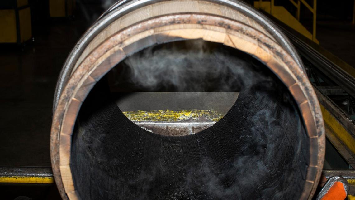 Bourbon barrels made from white oak logs are charred inside on Dec. 13, 2021 as part of the production process at Cumberland Cooperage in East Bernstandt, Ky. The charring imparts color and flavor to the bourbon.