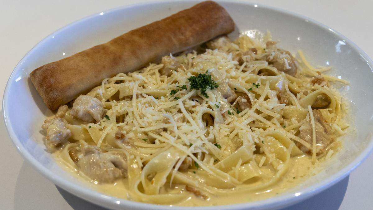 Fettuccini Alfredo with chicken ($16.25) at Nothing But Noodles. Many of the pasta dishes on the menu come with a breadstick. 