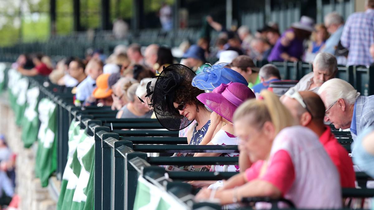 Derby finery was on full display Saturday as thousands of racing fans gathered at Keeneland Race Course to watch and wager on the Kentucky Derby.