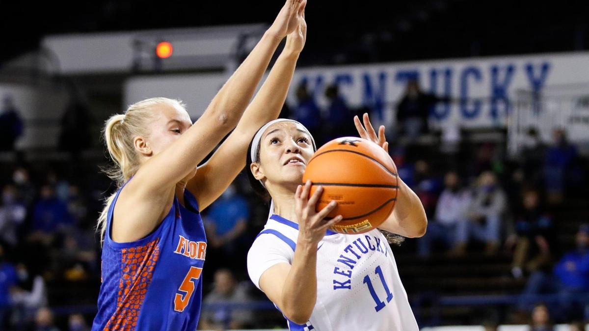 Kentucky Wildcats guard Jada Walker (11) jumps trying to score with the ball while defended by Florida Gators guard Alberte Rimdal (5) during the game at Memorial Coliseum in Lexington, Ky., Thursday, January 20, 2022.