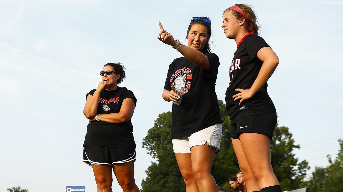 Paul Laurence Dunbar girls’ soccer head coach Megan Poage, center, instructed Alison O’Hara as she was about to be subbed in during their game against Madison Southern on Tuesday in the Fayette County Soccer Spectacular at Henry Clay High School. At left is goalie coach Caitlin Wohlander. Another assistant, Arly Lankster, was leading junior varsity practice back on campus.