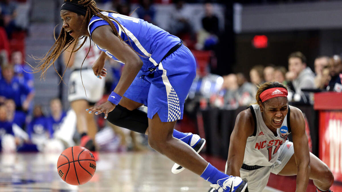 North Carolina State’s Kiara Leslie, right, fell while Kentucky’s Rhyne Howard dribbled away during the first half Monday night in Raleigh, N.C.
