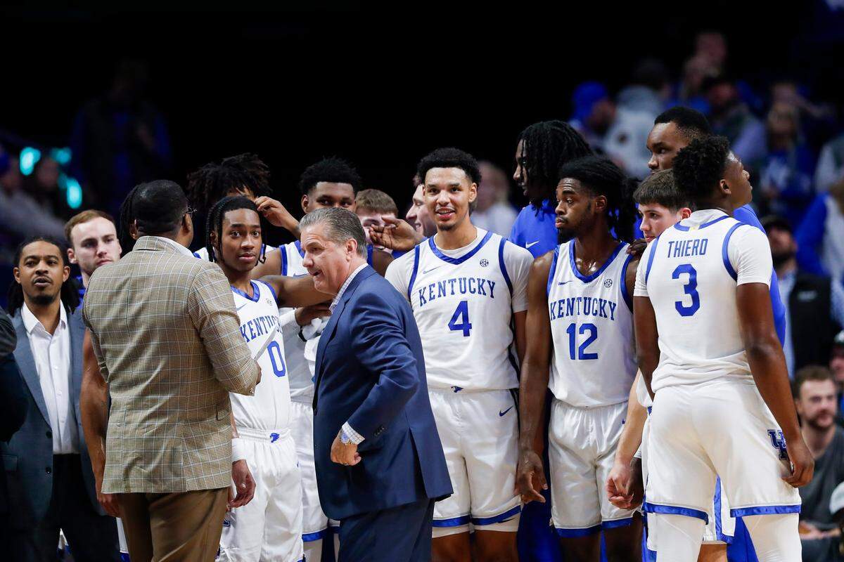 The Kentucky Wildcats huddle with coach John Calipari during a timeout against Marshall on Friday night in Rupp Arena.