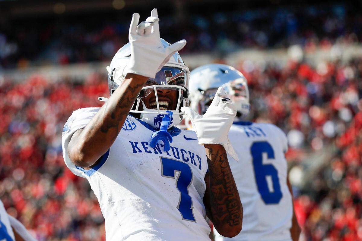 Kentucky wide receiver Barion Brown (7) celebrates a touchdown by teammate Dane Key (6) to tie the game against Louisville.