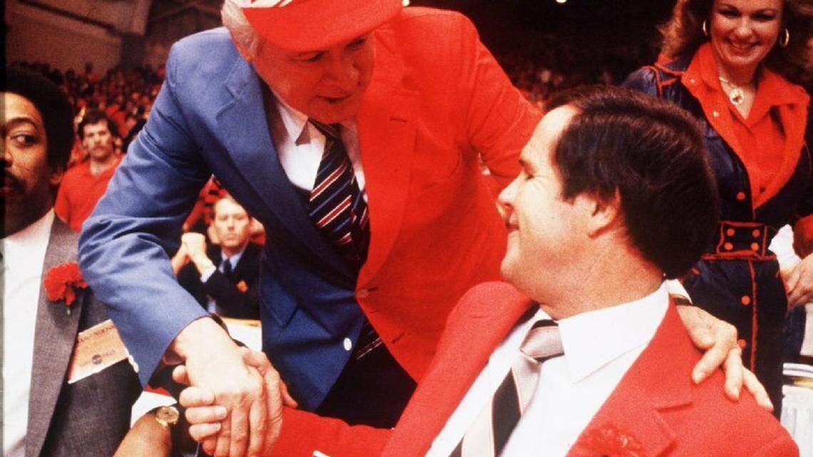 Then-Kentucky Gov. John Y. Brown Jr., wearing a blue and red sport coat and cap representing both the University of Kentucky and the University of Louisville greeted U of L Coach Denny Crum prior to the NCAA Tournament Mideast Regional finals in Knoxville, Tenn., on March 26, 1983. Louisville won the first “Dream Game” between the two state schools, 80-68. At right rear was Brown’s wife, Phyllis George Brown. John Y. Brown died last fall. Phyllis George died in 2020.