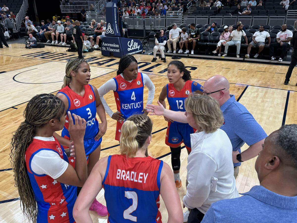 The Kentucky senior girls all-stars huddle up during a timeout in Saturday’s game against Indiana in Indianapolis.