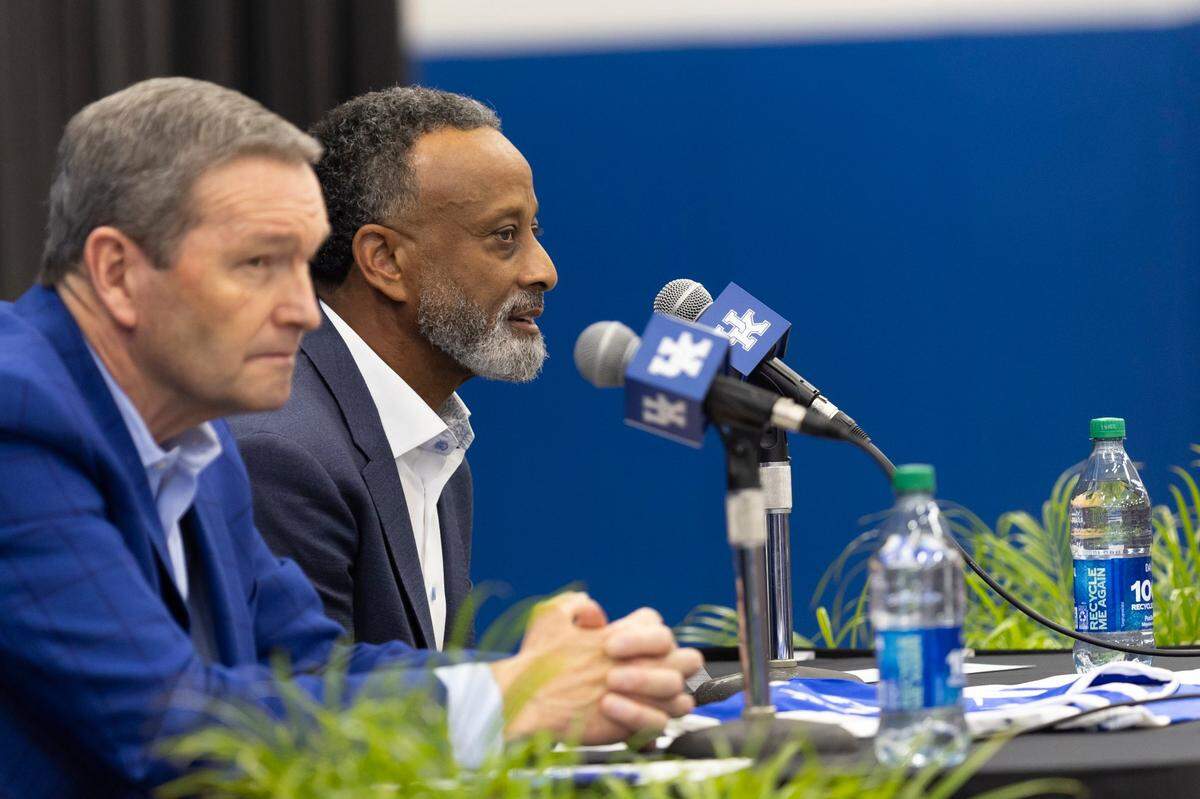 Kenny Brooks, right, spoke during his introductory press conference as the head coach of Kentucky women’s basketball with UK athletics director Mitch Barnhart in the foreground. “I think this is a sleeping giant,” Brooks said of Kentucky women’s basketball.