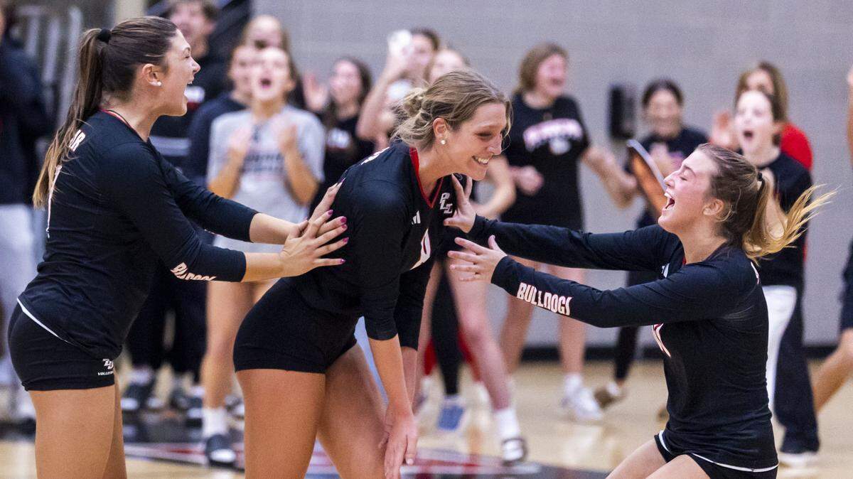Paul Laurence Dunbar's Mia Pendley (8), center, celebrates with Paul Laurence Dunbar's Sloan Atkins (17), left, and Paul Laurence Dunbar's Mia Claire Barnes (10) after the Bulldogs rallied and won the third set during its 3-1 win over Lexington Catholic in the 43rd District Girls Volleyball Championship game, Thursday, Oct. 23, 2025 at Paul Laurence Dunbar High School in Lexington, Ky. LexCath had set point at 24-15 but Dunbar came from behind for the 29-27 second set win, propelling them to the victory.