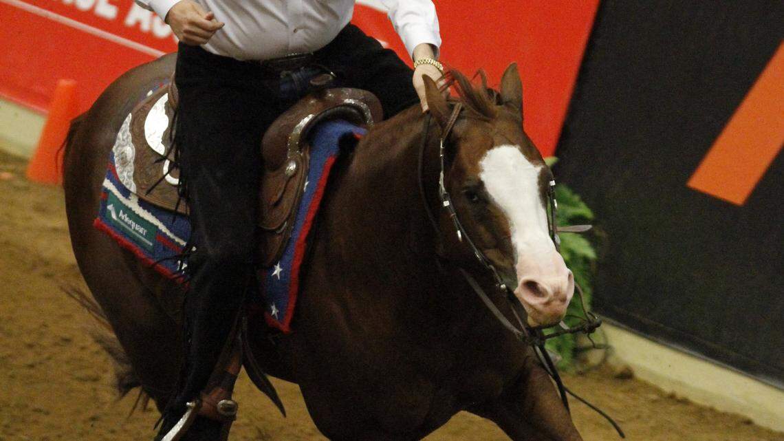 American Tom McCutcheon made a right turn on Gunners Special Nite during their gold medal-winning ride at the World  Equestrian Games' individual reining event Thursday. Craig Schmersal, also of the United States, took silver. 
   
