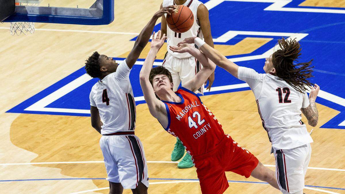 Marshall County's Matthew Langhi (42) has his shot blocked by George Rogers Clark's Jamylyn Johnson (4) and George Rogers Clark's Amari Bartelson (12) also defends during a quarterfinal round game in the 2026 UK HealthCare Boys' Basketball Sweet 16 state tournament, Friday, March 20, 2026 at Rupp Arena in Lexington, Ky.