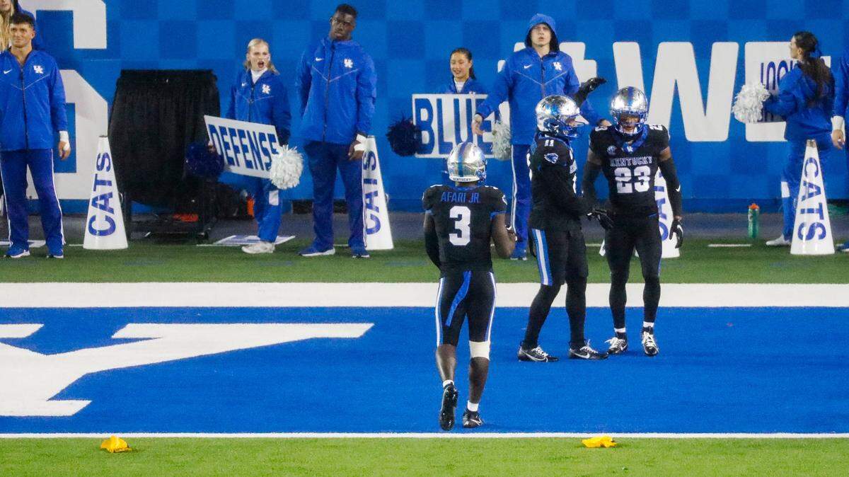 Kentucky’s Alex Afari Jr. (3) and Zion Childress (11) console defensive back Andru Phillips (23) after Phillips was called for pass interference during Saturday’s game against Missouri.