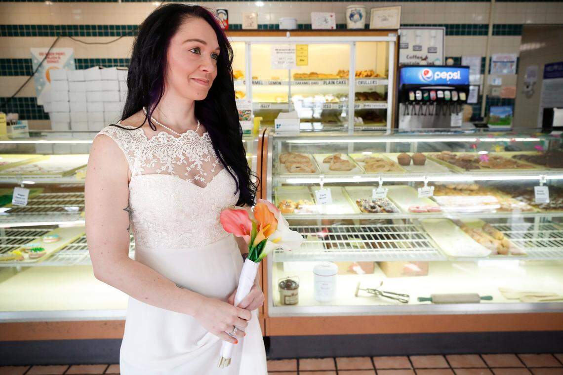 Heather Sutton, of Lexington, Ky., waits before her wedding ceremony at Donut Days Bakery in Lexington, Ky., Friday, March 19, 2021.