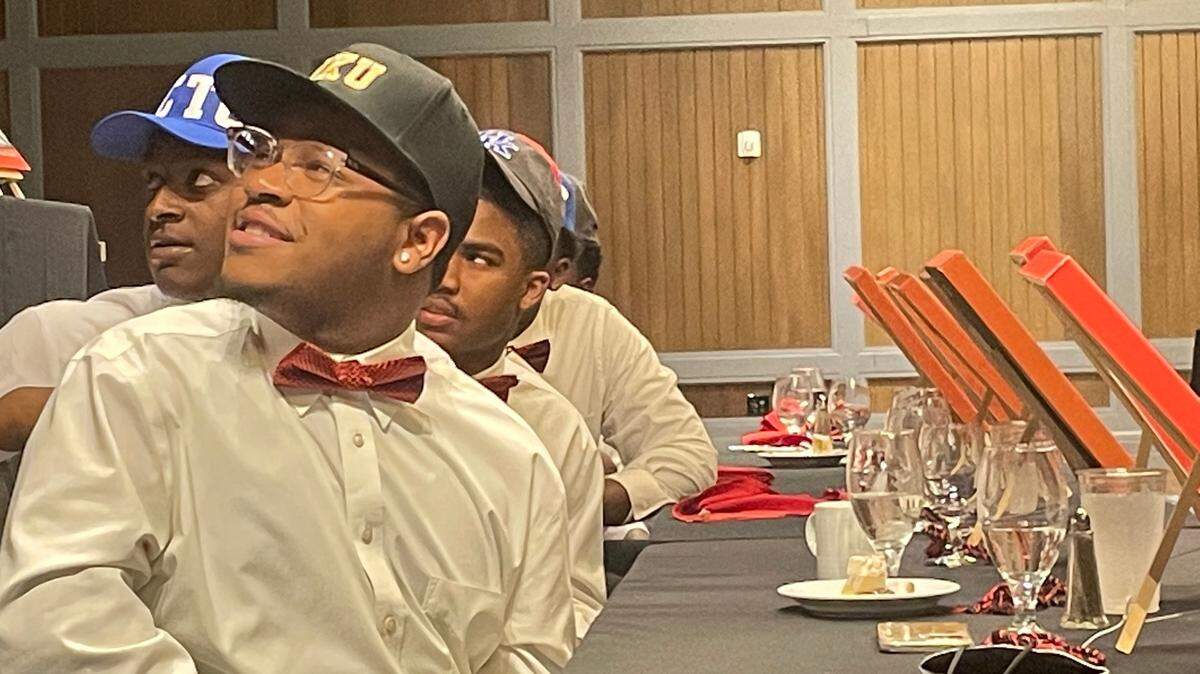 Jathan Briscoe, a senior of the BMWA, smiles up at the podium during his academic signing celebration on Sunday.