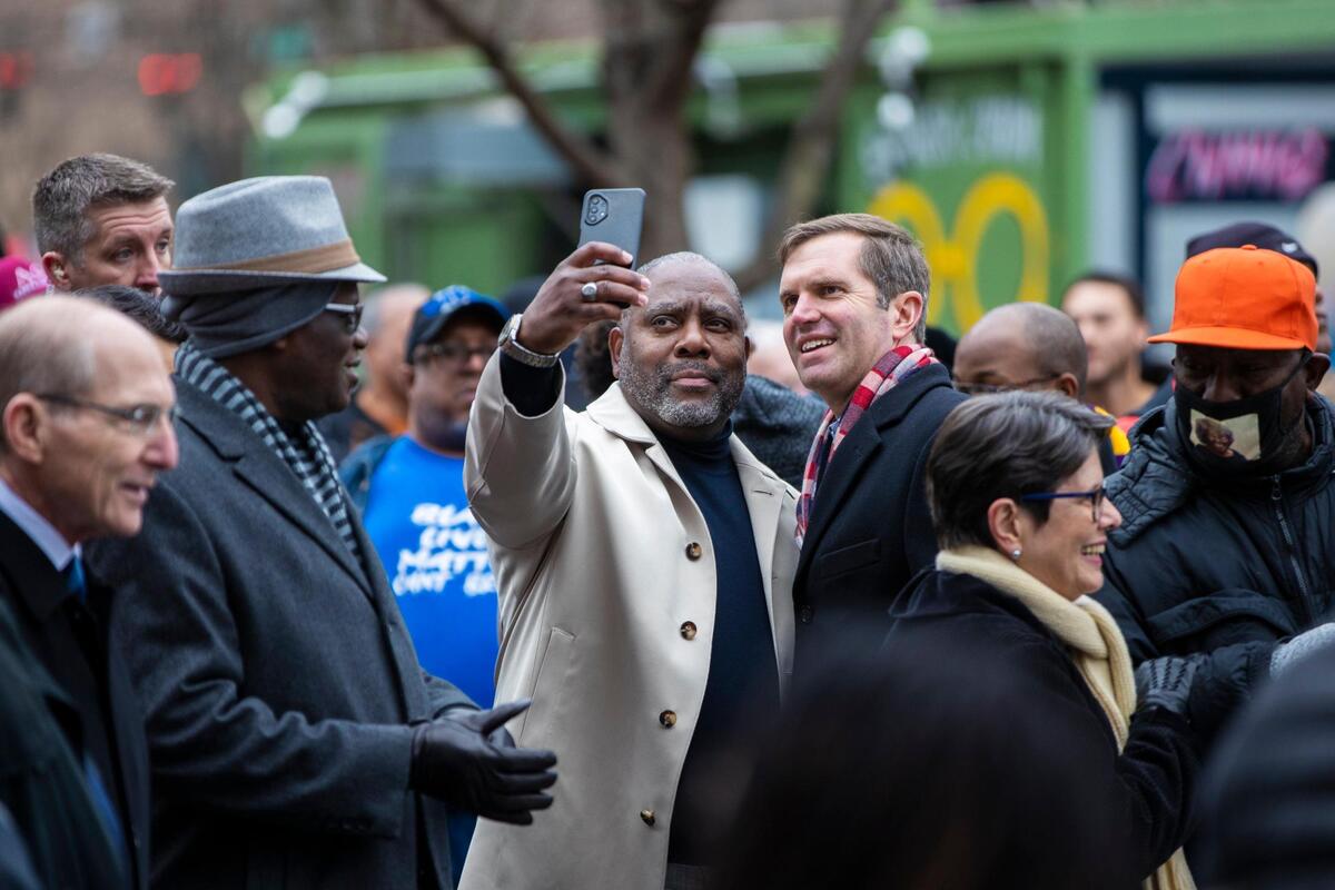 People take photos with Gov. Andy Beshear after marching during the city’s 50th anniversary of Martin Luther King Jr. celebrations at starting at the Central Bank Center in Lexington, Ky., Monday, January 16, 2023.