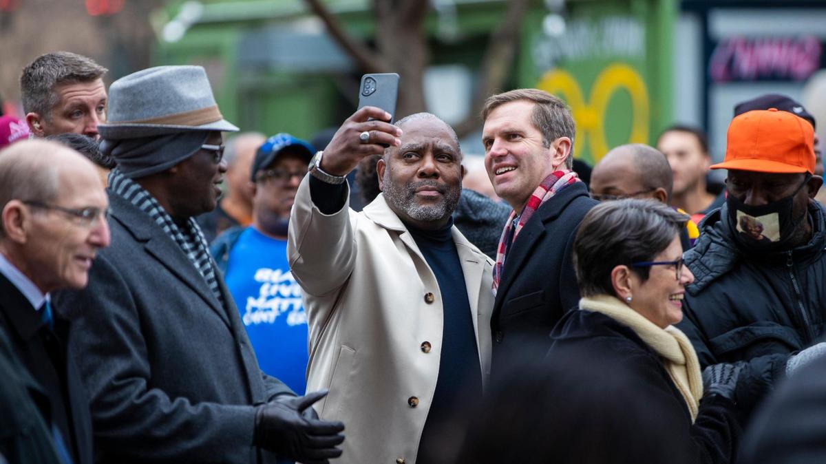 People take photos with Gov. Andy Beshear after marching during the city’s 50th anniversary of Martin Luther King Jr. celebrations at starting at the Central Bank Center in Lexington, Ky., Monday, January 16, 2023.