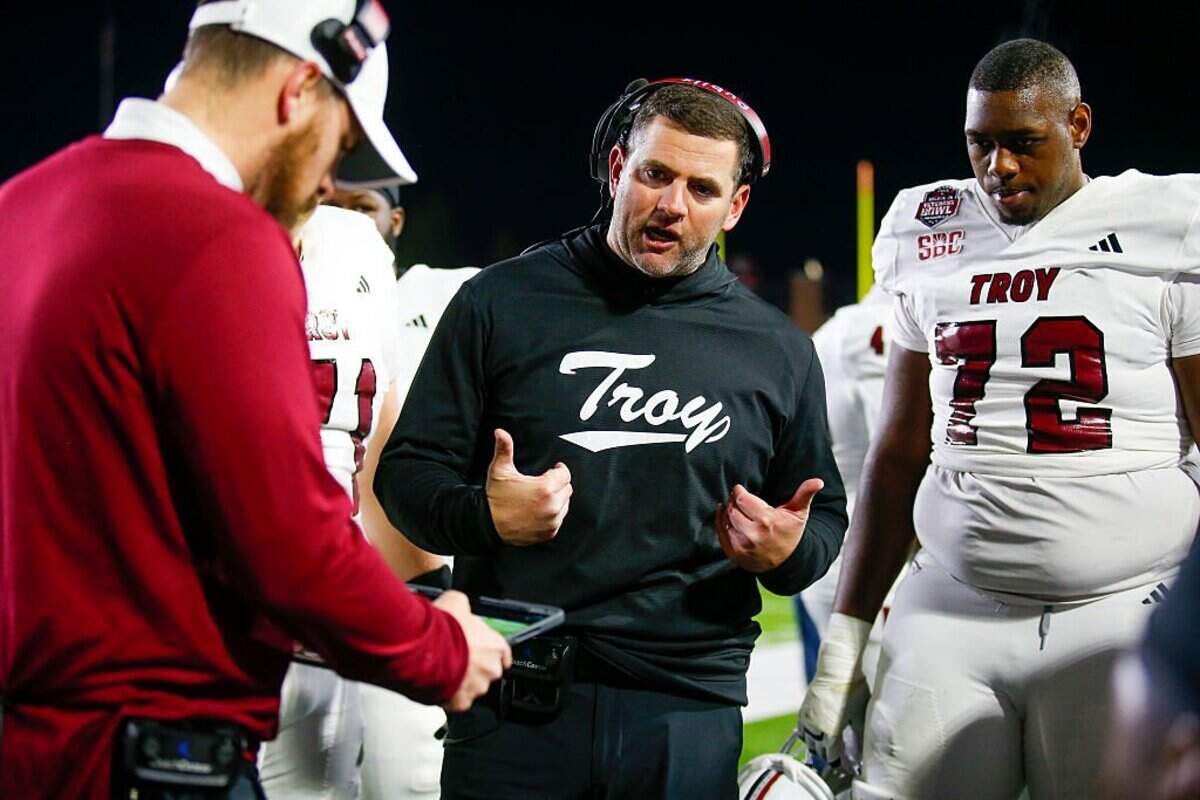 Former Kentucky Wildcats wide receiver and graduate assistant Gerad Parker, center, led Troy (8-6) to the Sun Belt Conference West Division title in 2025. The Trojans have been picked to repeat as division champs in the SBC preseason coaches’ poll.