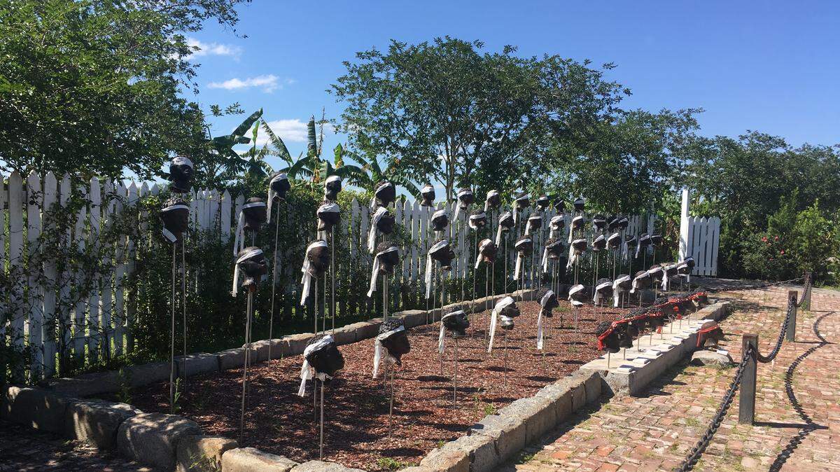 From January 8–10, 1811, the largest slave revolt in the U.S. South erupted on the German Coast of Louisiana, involving about 500 slaves. Dozens of slaves were condemned to death, executed, and beheaded, at the plantations to which they belonged. The heads were planted on poles. To create what could be the most extraordinary memorial, the Whitney Museum commissioned Woodrow Nash to create 63 ceramic heads depicting the revolutionaries mounted on steel rods along a pond designed to resemble a meander of the Mississippi River. The cloths are tied around the heads in February when, each year, the grounds are blessed. They represent crowns for the warriors who fought in the revolt.