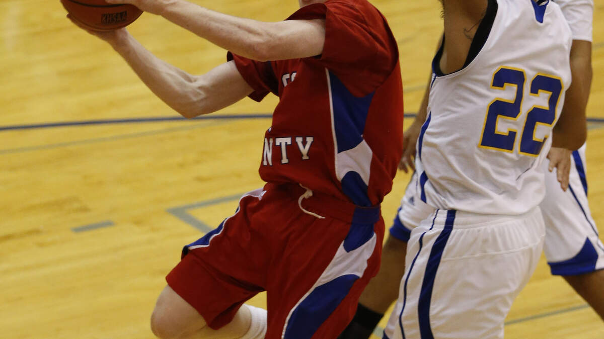 Scott County's Trent Gilbert drove to the basket against Henry Clay's Darien Tichenor during the Cardinals' victory in the 42nd District Tournament Thursday night in Georgetown. Gilbert led the winners with 29 points.      