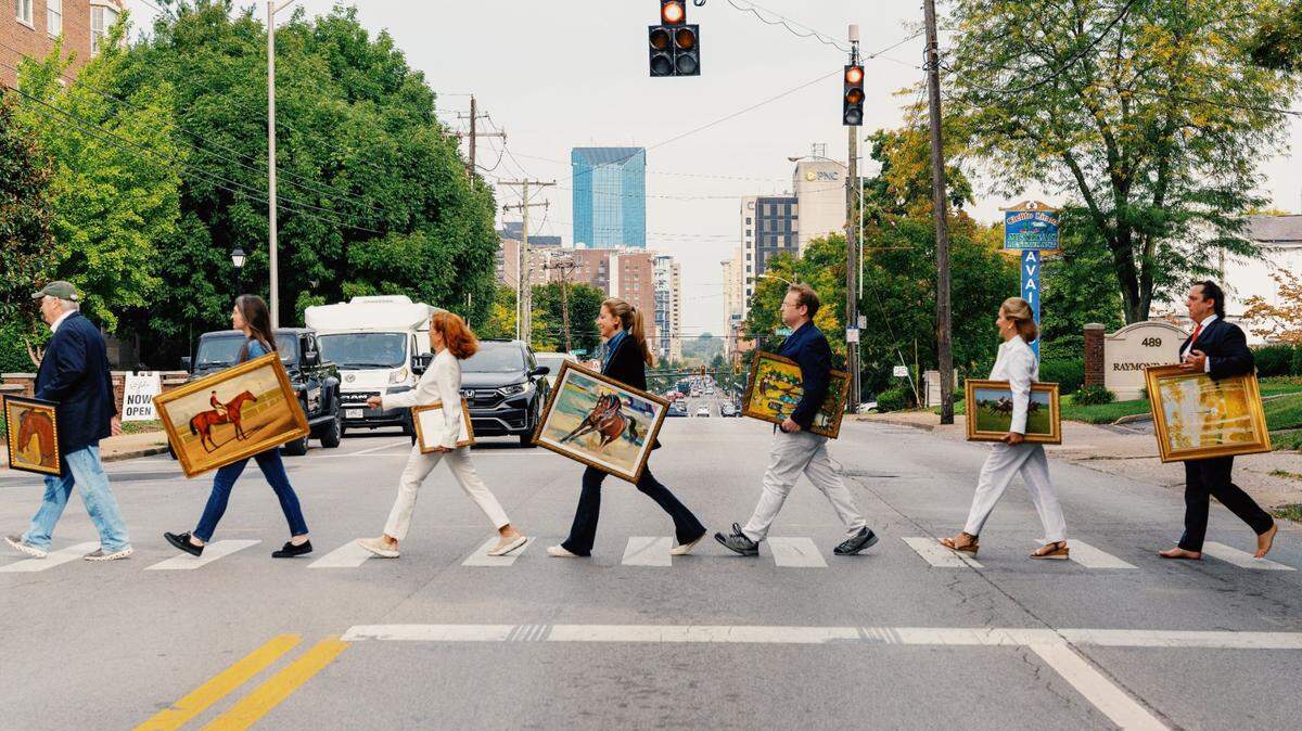 Employees of Crossgate Gallery staged an Abbey Road style photo, moving paintings from their longtime gallery on Main Street to the new home on Old Vine.