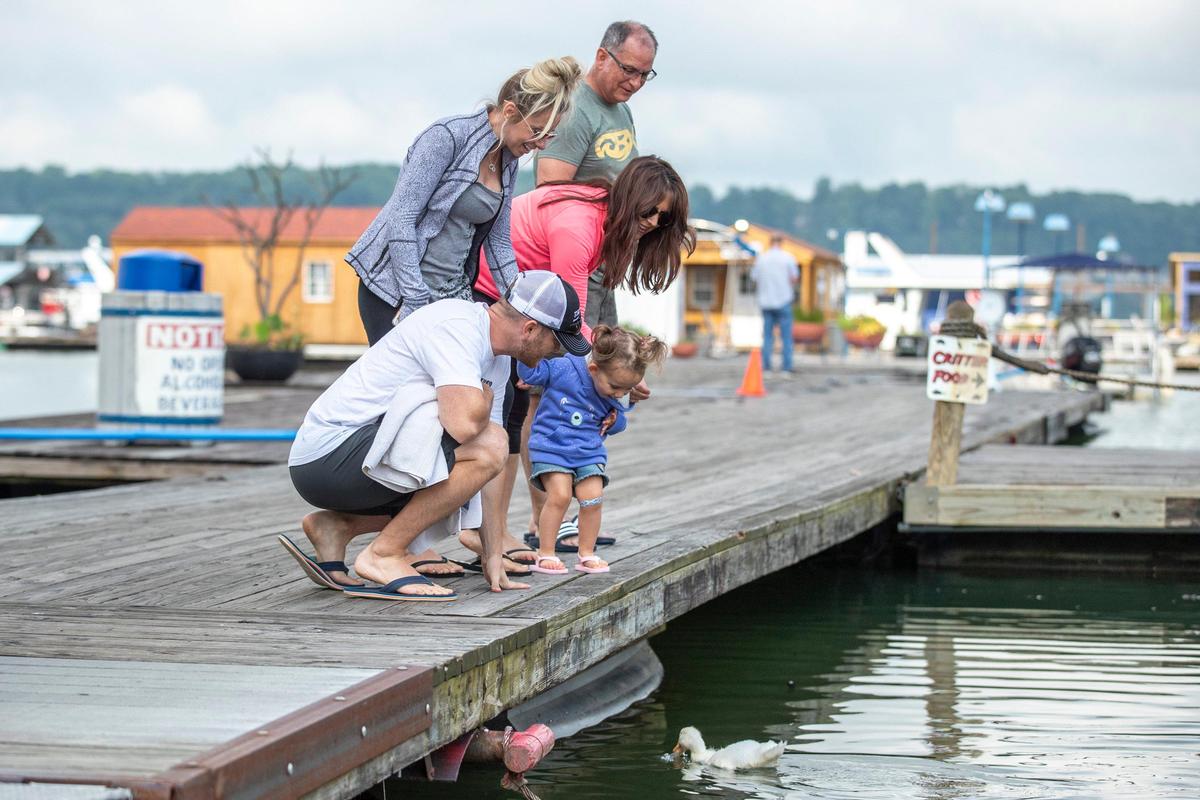 Daniel, kneeling, and Danielle Pinkstock, with their 2-year-old daughter, Landry, of Texas, feed geese, with Dana and Don Pinkstock, of Pennsylvania, at Conley Bottom Resort near Monticello, Ky., on Lake Cumberland on Tuesday, May 19, 2020. The resort is preparing for the start of the summer season.
