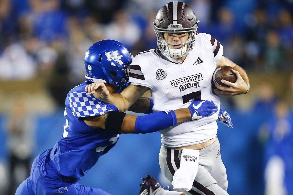 Jordan Jones (34) and the Kentucky defense held Mississippi State quarterback Nick Fitzgerald (7) to a net of 20 yards rushing Saturday night in UK’s 28-7 victory over the No. 14 Bulldogs.