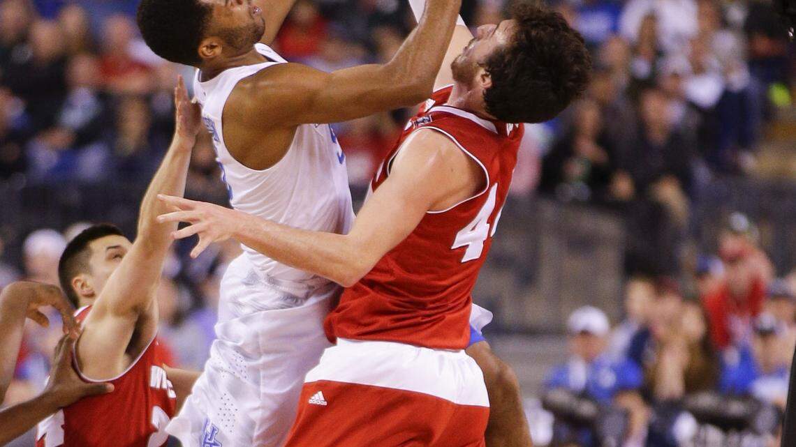 Kentucky guard Andrew Harrison scored over Wisconsin forward Frank Kaminsky on Saturday in a Final Four game in Indianapolis. Harrison finished with 13 points and four assists, but Wisconsin won, 71-64, to end Kentucky's pursuit of a perfect season and a ninth national championship.
