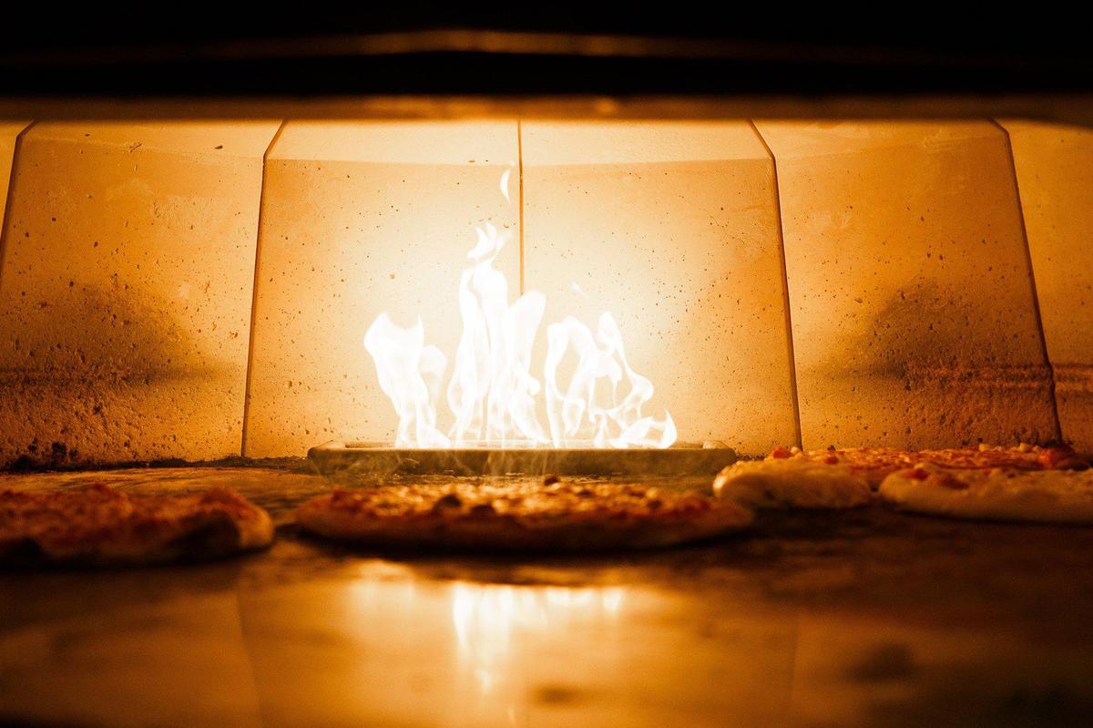Pizzas at The Works Brick Oven are baked in a 600-degree old-fashioned brick oven.