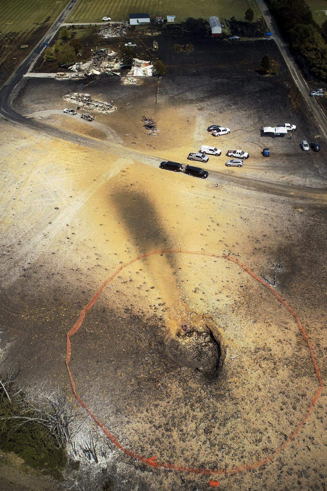 A hole in the ground is left following a gas line explosion that destroyed property and left one woman dead in Moreland, Ky., Thursday, Aug. 1, 2019.