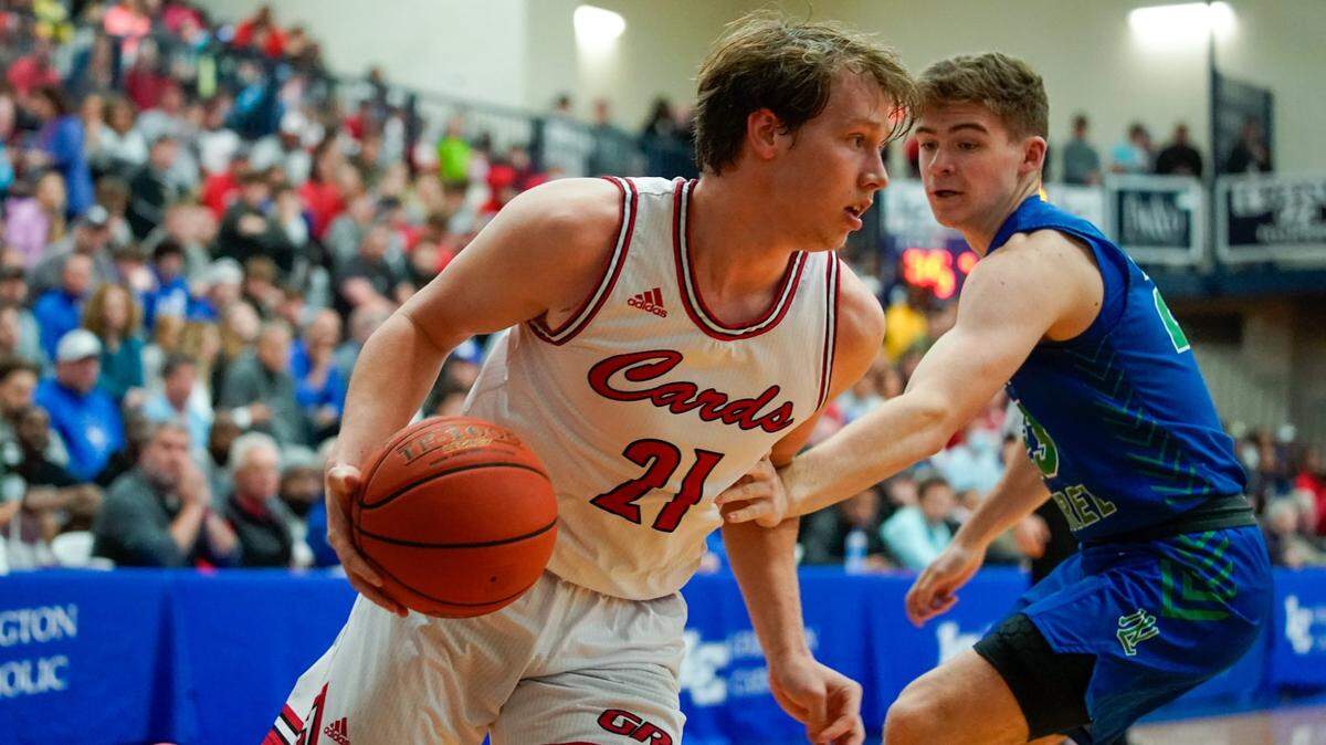 Clark County’s Tanner Walton (21) drove past North Laurel’s Brody Brock during a 77-64 Cardinals victory at Lexington Catholic on Dec. 28, 2021.